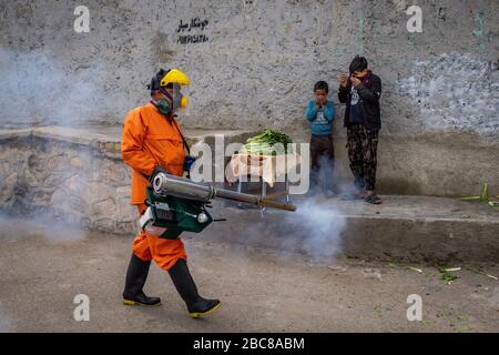 The Iranian health ministry, provincial fire department and municipal staffs disinfect the streets and other public places against Coronavirus(Covid-19) using machinery and mobile pumps in Shiraz, Fars province, Iran. April, 2020. Stock Photo