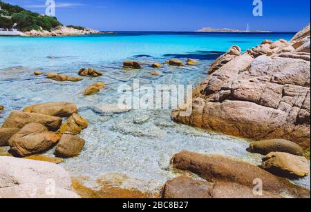 Clear amazing azure and turquoise colored sea water with huge granite rocks in Capriccioli beach, Sardinia, Italy. Stock Photo