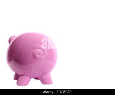 Horizontal shot of a pink piggy bank facing away from the camera on the left side of the picture.  Curly tail.  Lots of copy space on the right side. Stock Photo