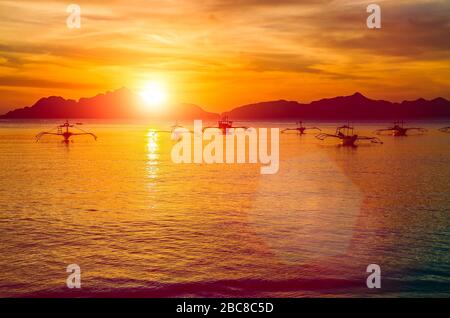 Traditional philippino boats at El Nido bay in sunset lights. Palawan island, Philippines. Stock Photo
