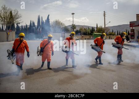 The Iranian health ministry, provincial fire department and municipal staffs disinfect the streets and other public places against Coronavirus(Covid-19) using machinery and mobile pumps in Shiraz, Fars province, Iran. April, 2020. Stock Photo