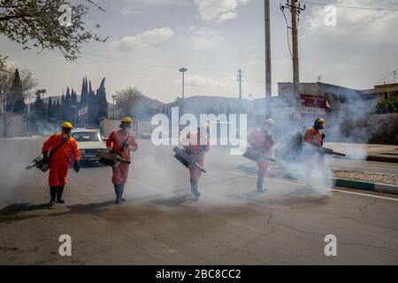 The Iranian health ministry, provincial fire department and municipal staffs disinfect the streets and other public places against Coronavirus(Covid-19) using machinery and mobile pumps in Shiraz, Fars province, Iran. April, 2020. Stock Photo