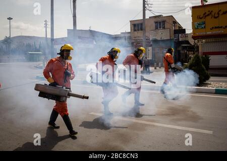 The Iranian health ministry, provincial fire department and municipal staffs disinfect the streets and other public places against Coronavirus(Covid-19) using machinery and mobile pumps in Shiraz, Fars province, Iran. April, 2020. Stock Photo