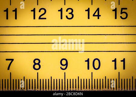 Yellow metal ruler close up with millimeters and centimeters Stock Photo