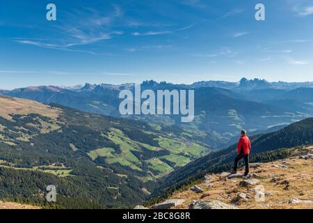 Latzfons, Klausen, Bolzano province, South Tyrol, Italy, Europe. A hiker admires the mountain panorama from Jocherer Berg. In the background the Dolom Stock Photo