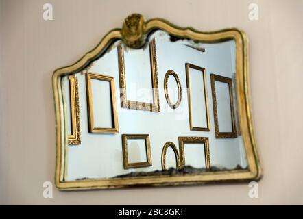 an empty room with empty art frames reflecting in a mirror Stock Photo