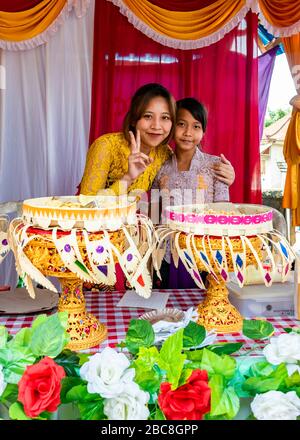 Vertical portrait of young girls at a Balinese wedding, Indonesia. Stock Photo