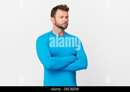 Handsome man in blue sport costume portrait against white background Stock Photo