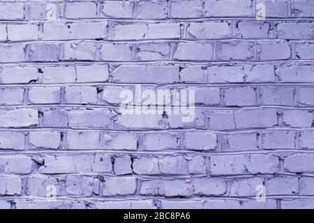 Brick wall painted in violet color, background Stock Photo