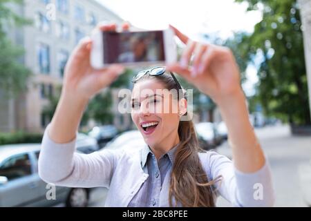 Woman taking photo outside Stock Photo