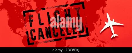 Flights canceled banner with world map and airplane model on red background. Coronavirus Pandemic, Covid 19 Stock Photo