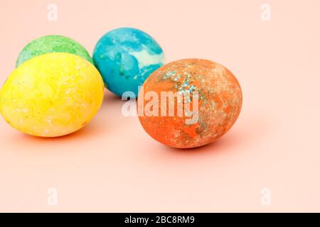 Four multi-colored Easter eggs top view, space for text. Concept happy easter day. Stock Photo