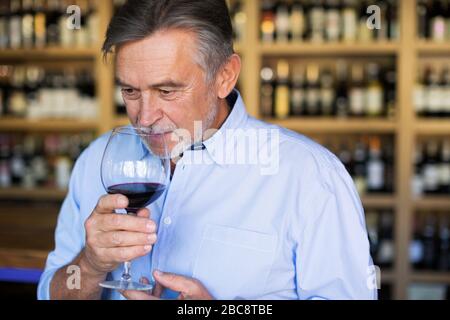 Man working in wine shop Stock Photo