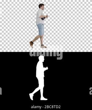 Young man playing a ukulele, singing and walking, Alpha Channel Stock Photo