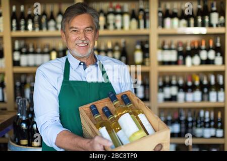 Man working in wine shop Stock Photo