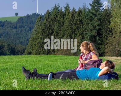 Hiking on the second valley trail, rest on mountain pasture at Kreuzmoos, view towards Bidlstein Stock Photo