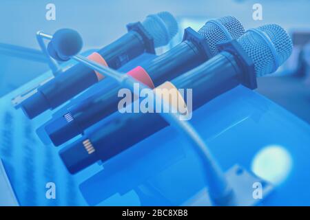 Wireless microphones on the table. Close up of microphones in conference room. Closeup at business conference. Stock Photo