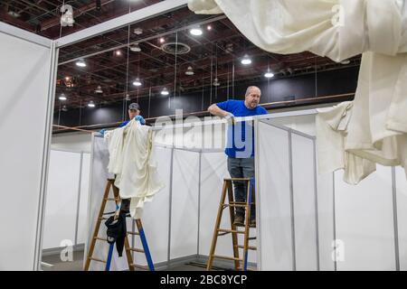 Detroit, Michigan, USA. 2nd Apr, 2020. Workers construct an emergency field hospital at the TCF convention center. The 1,000-bed hospital will care for Covid-19 patients. Credit: Jim West/Alamy Live News Stock Photo