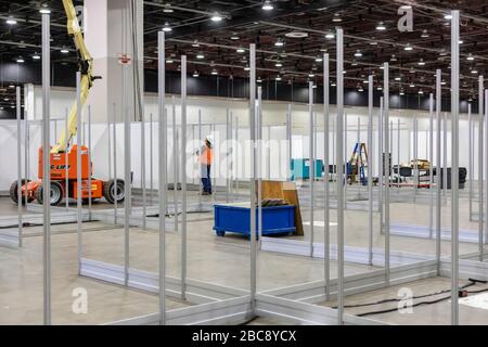 Detroit, Michigan, USA. 2nd Apr, 2020. Workers construct an emergency field hospital at the TCF convention center. The 1,000-bed hospital will care for Covid-19 patients. Credit: Jim West/Alamy Live News Stock Photo