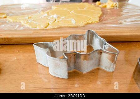 Easter bunny baking tin from sheet with flour and fresh dough Stock Photo