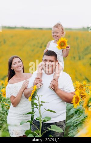 Mother with baby son in sunflower field Stock Photo - Alamy