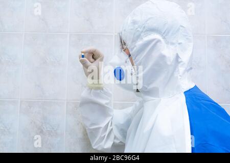 Blue and white pill in doctors hand with gloves closeup. Sickness cure concept, Selective focus. Stock Photo