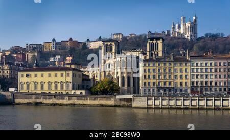View over the Saone river to the Notre Dame de Fourvière basilica in Lyon and the Saint Jean Baptiste cathedral, monument historique