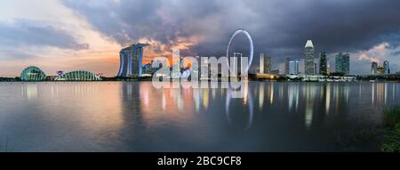 Panorama of Singapore's central district skyline, from across Marina Bay reservoir, with the Gardens by the Bay, the Sands Resort, the financial distr Stock Photo