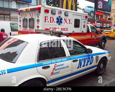 FDNY ambulance passing an NYPD car, Manhattan, New York City, USA Stock Photo