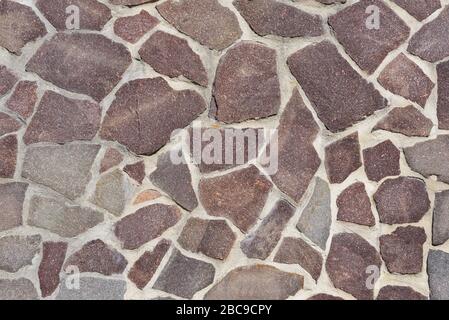Background, texture and close-up of a wall decorated with flat natural stones Stock Photo
