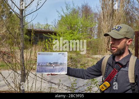 Pripyat, Ukraine - April 25 2019: Destroyed building and photo as it was before the Chernobyl disaster. Pripyat, exclusion zone Stock Photo