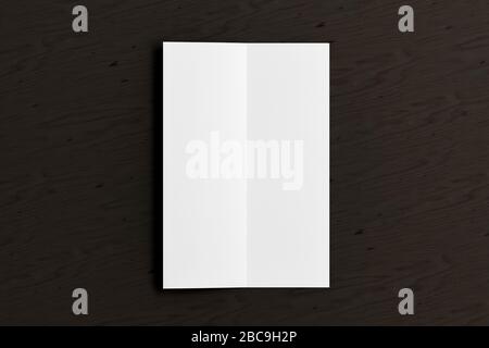 Blank vertical A4 leaflet on black wooden background. Bi-fold or half-fold opened brochure isolated with clipping path. View directly above. 3d illust Stock Photo