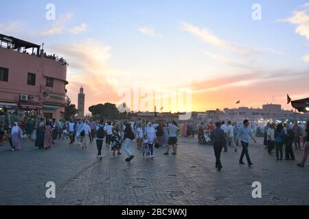 Crowds of locals and tourists mill at sunset in Djemma El Fna, Marrakech's main square. Stock Photo