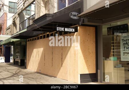 Vancouver, Canada - Apr 2, 2020: Vancouver shops have boarded up their storefronts with wood following an increase in break-and-enters due to COVID-19 Stock Photo