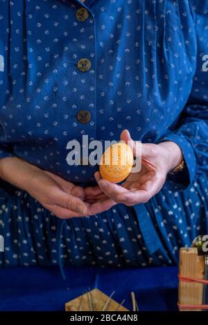 A woman holds a Sorbian Easter egg in her hand. It was decorated with the wax batik technique. Stock Photo