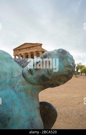 Modern sculpture of Icarus in front of the Temple of Concordia, Valley of the Temples, Agrigento, Sicily, Italy Stock Photo