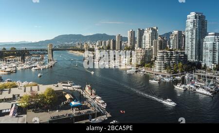 Beautiful city of Vancouver during summer. So many boats, sails, nice modern buildings, ocean and mountains. Stock Photo