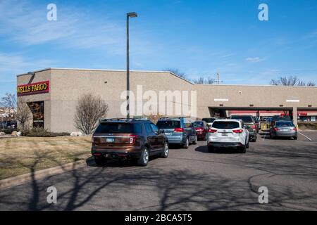 Maplewood, Minnesota.  With the inside lobby closed traffic backs up at the drive up window at the Wells Fargo bank as people take money out due to th Stock Photo