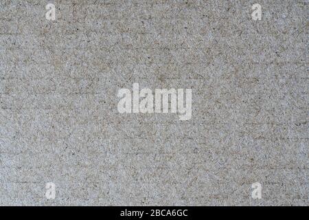 Close-up detail view of light brown background from sheet of recycled cardboard. Abstract texture recycled eco-friendly material pattern background Stock Photo