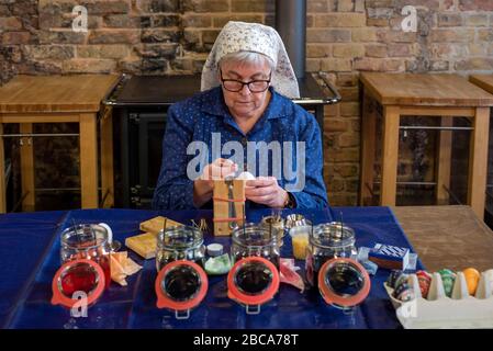 Sorbian Easter eggs, woman decorates Easter eggs, the Sorbs are famous for their artistic decoration of Easter eggs. Stock Photo