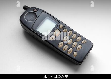 Old cellular push-button telephone close-up on a white windowsill. Stock Photo