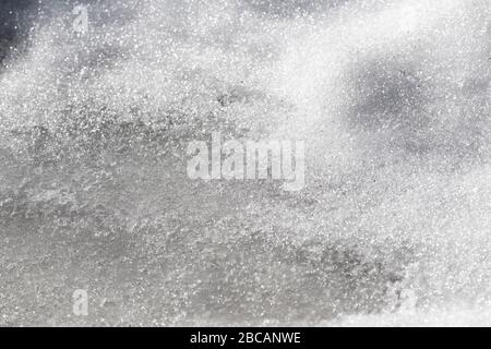 The surface of the melting snow closeup as a background. Stock Photo