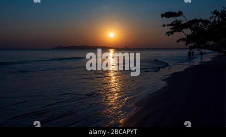 The golden glow of sunrise and the reflections of the rising sun on the water Stock Photo
