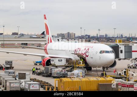 Air Canada Rouge Boeing 767 aircraft is seen at gate being loaded with cargo at Toronto Pearson Intl. Airport. Stock Photo