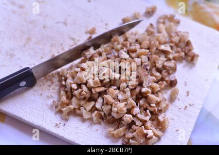 chopped walnuts on a chopping board Stock Photo