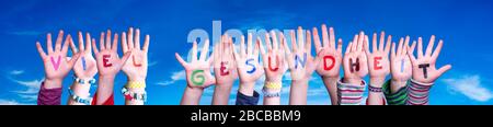 Kids Hands Holding Word Viel Gesundheit Means Stay Healthy, Blue Sky Stock Photo