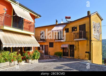 A narrow street between the houses of a small mountain village in the Basilicata region in Italy Stock Photo
