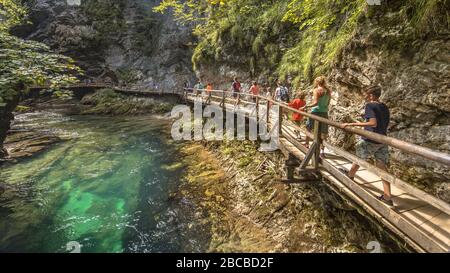 Soteska vintgar gorge with tourists walking on boardwalk along river on summer day Stock Photo