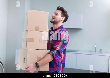 Young man carrying cardboard boxes Stock Photo
