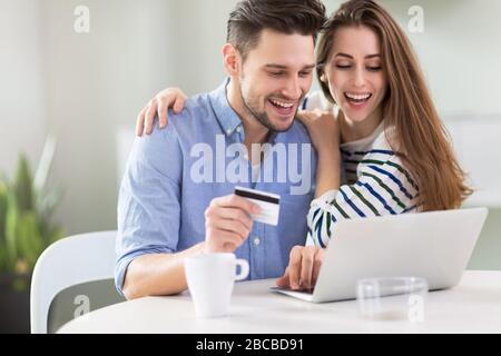 Couple using laptop together Stock Photo
